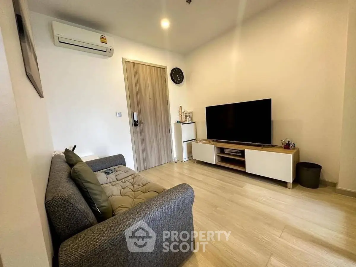 Modern living room with sleek furniture and wall-mounted TV, perfect for cozy relaxation.
