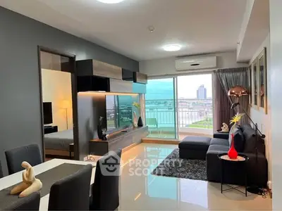 Modern living room with sleek furniture and stunning city view from balcony.