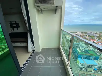 Stunning high-rise balcony with ocean view, perfect for relaxation and enjoying the scenery.