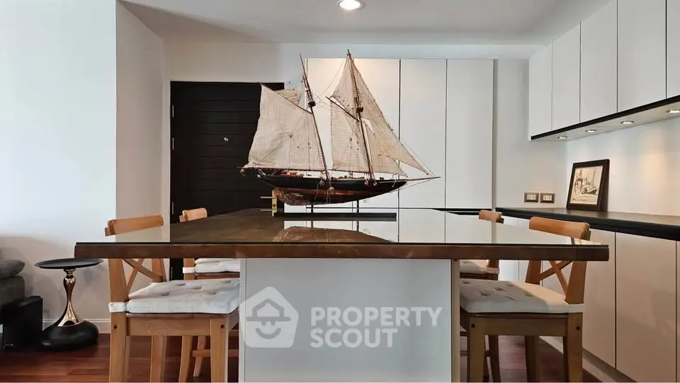 Modern kitchen with sleek cabinetry and nautical decor in stylish apartment