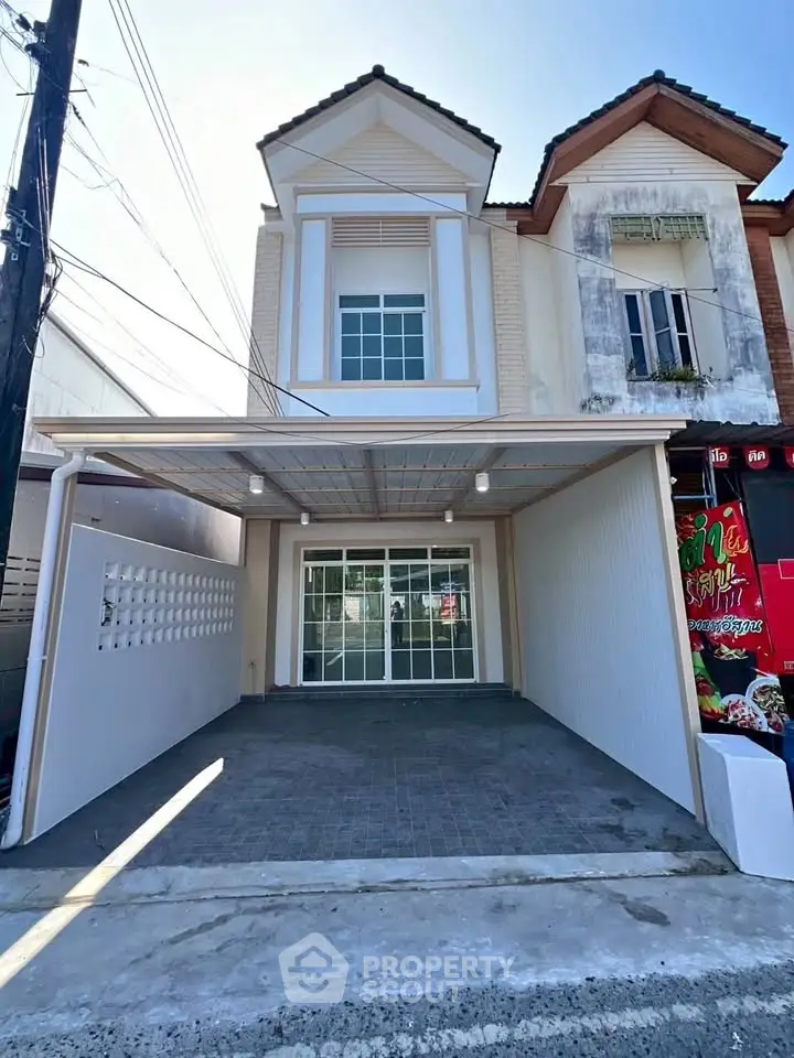 Charming townhouse with modern facade and spacious driveway in a serene neighborhood.