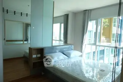 Modern bedroom with large windows and natural light in urban apartment