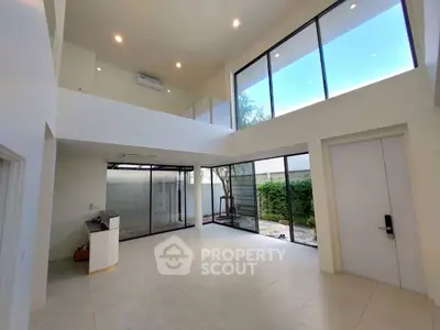 Spacious modern living room with high ceilings and large windows