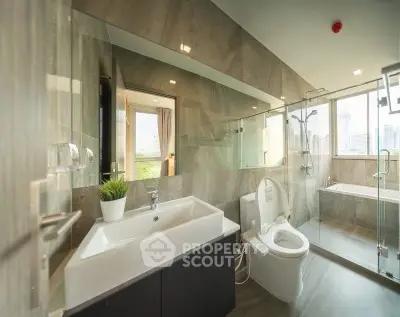 Luxurious modern bathroom with glass shower and city view