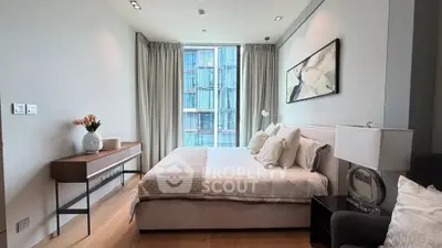 Luxurious modern bedroom with large window and elegant decor in high-rise apartment.