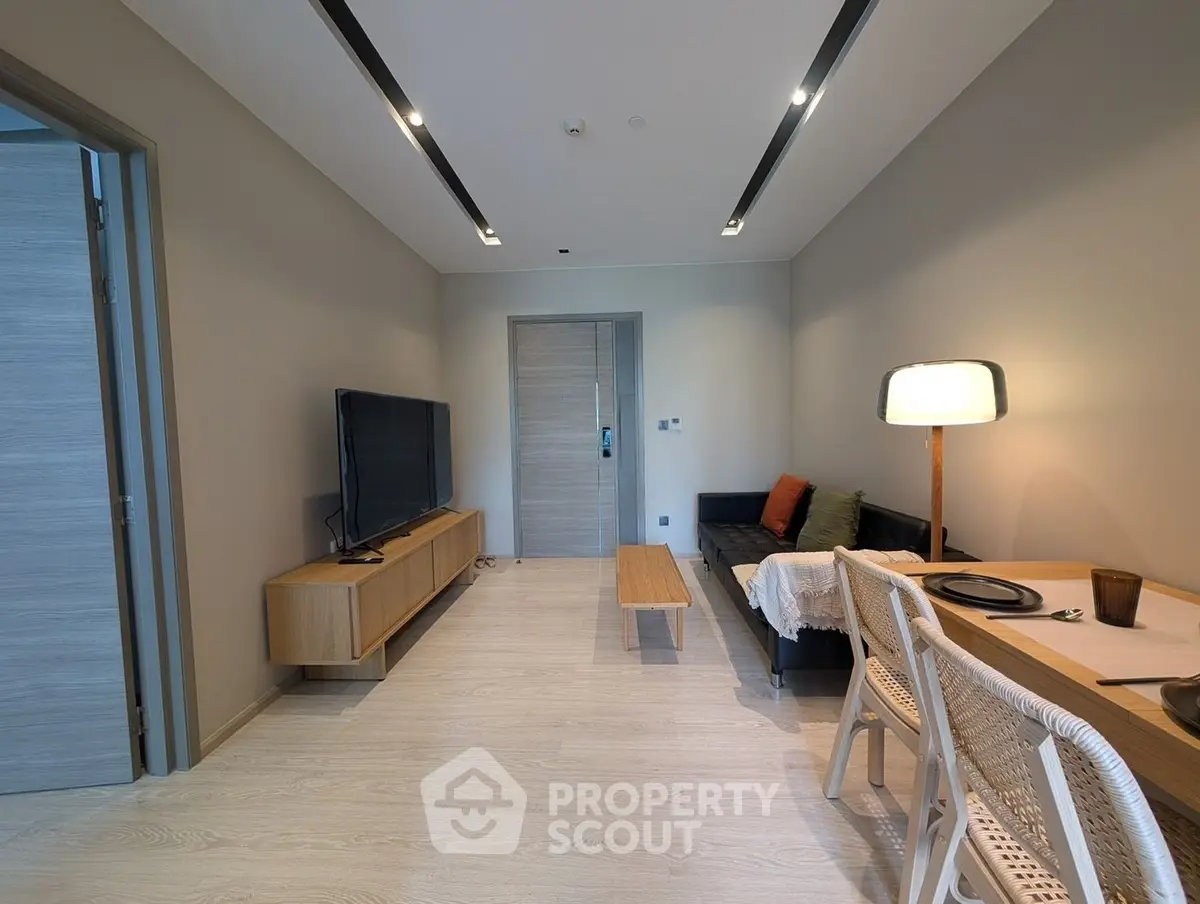 Modern living room with sleek furniture and ambient lighting, perfect for relaxation and entertainment.