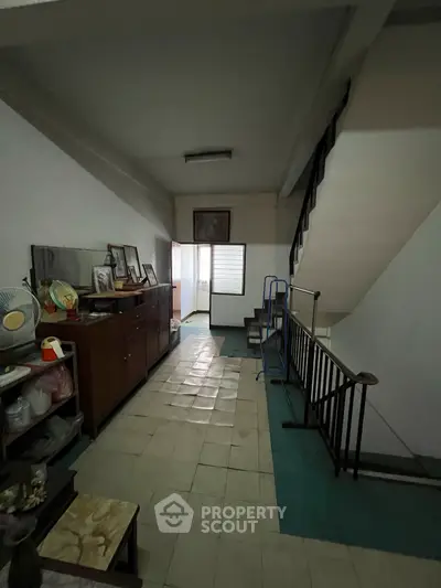 Charming vintage interior with staircase and retro decor, ideal for renovation enthusiasts.