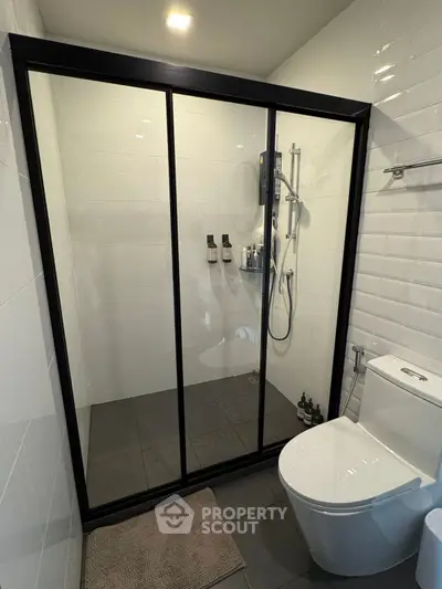 Modern bathroom with sleek shower enclosure and contemporary fixtures.
