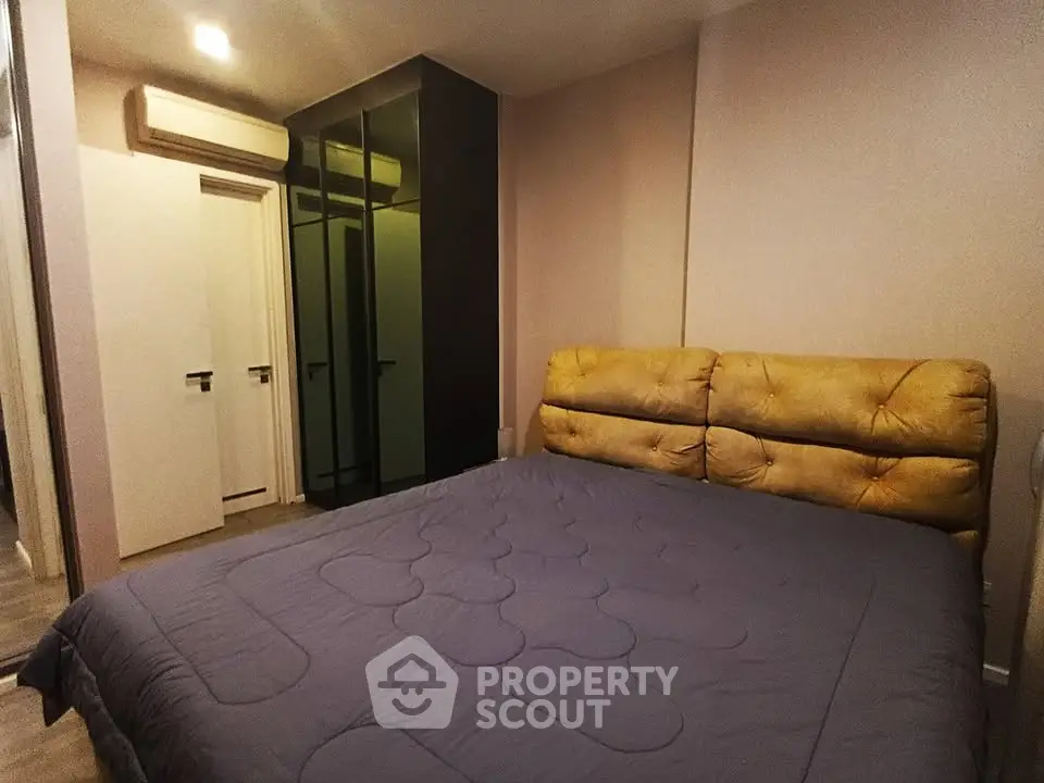 Spacious bedroom with modern design and ample closet space in a stylish apartment.