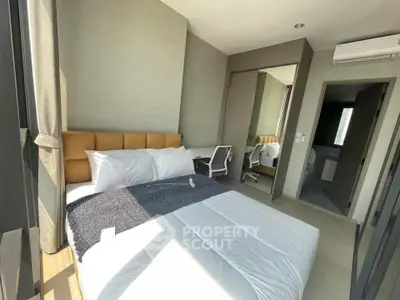 Modern bedroom with large window, stylish decor, and natural light.