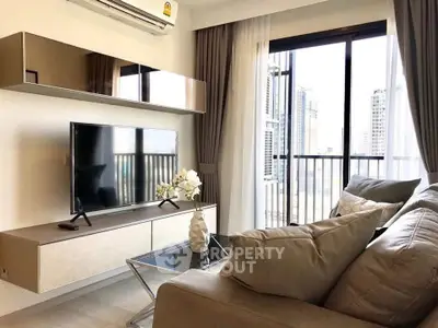 Modern living room with sleek furniture and city view balcony in a high-rise apartment.