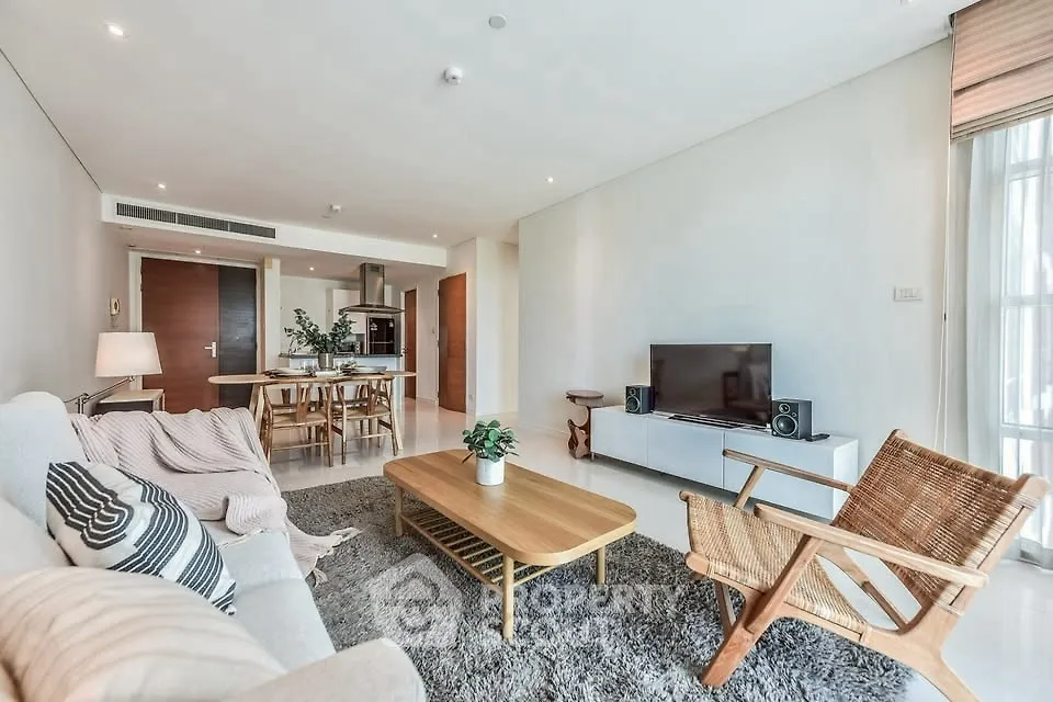 Spacious modern living room with stylish furniture and open kitchen layout