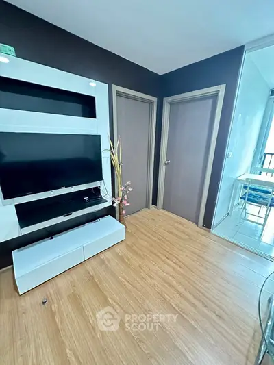 Modern living room with sleek TV unit and wooden flooring