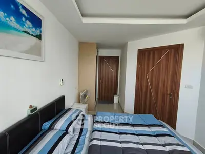 Modern bedroom with stylish decor and cozy bedding in a contemporary apartment.