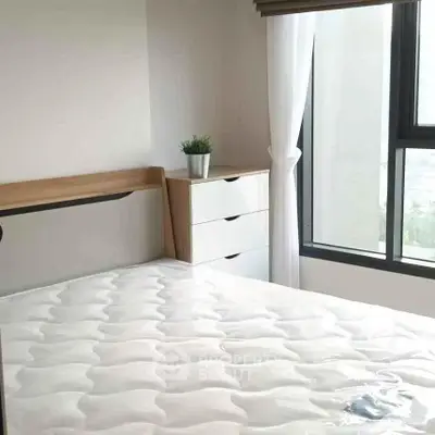 Bright bedroom with large window and modern furniture in a stylish apartment.