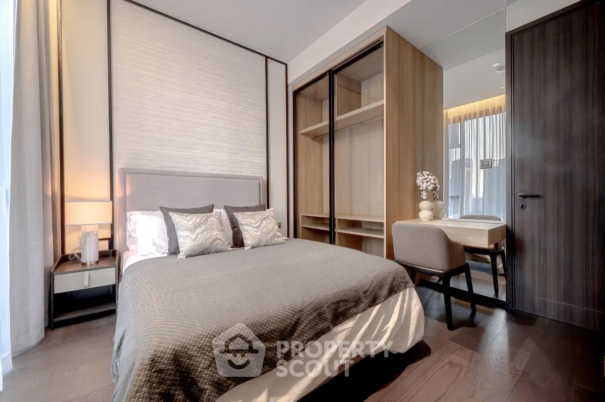 Modern bedroom with stylish decor and ample natural light, featuring a cozy bed and elegant furnishings.