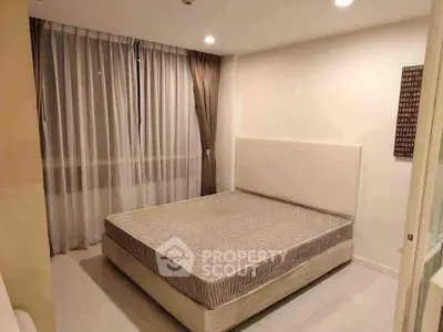 Modern bedroom with large window and minimalist decor in a stylish apartment.