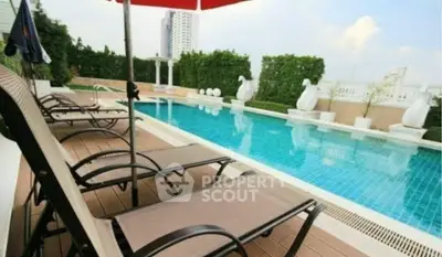 Luxurious rooftop pool with stylish loungers and city views, perfect for relaxation and leisure.
