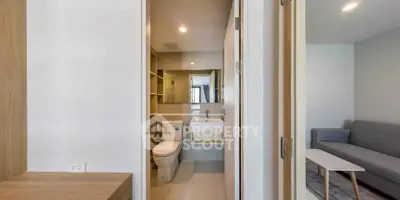 Modern apartment interior featuring a sleek bathroom and cozy living area with contemporary design.