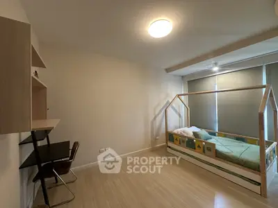 Spacious bedroom with modern wooden bed and study desk, perfect for a cozy and functional living space.