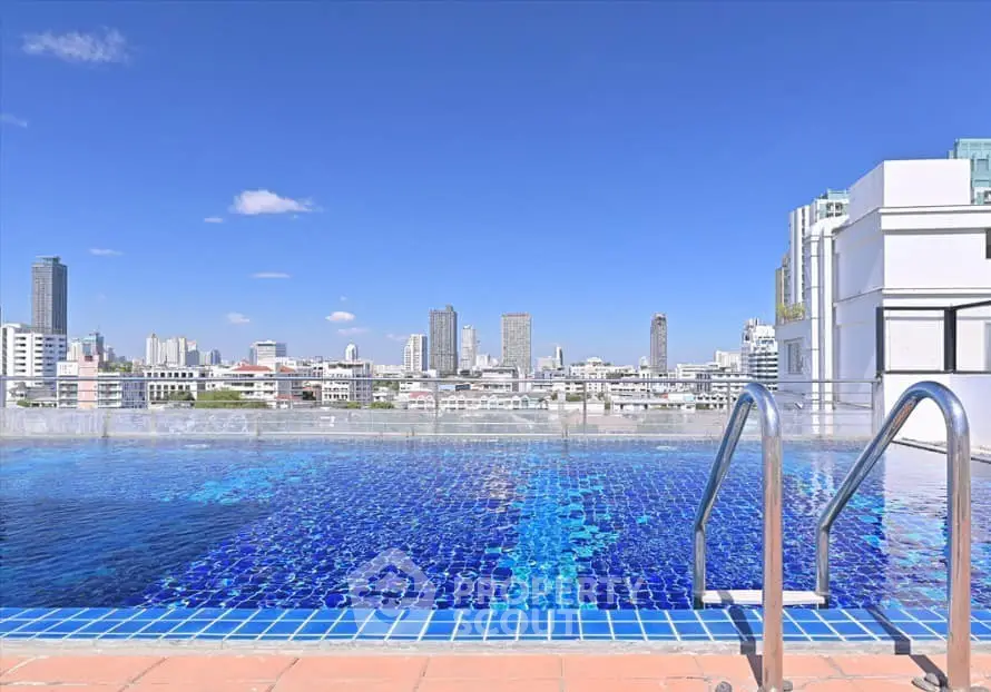 Stunning rooftop pool with panoramic city skyline views, perfect for relaxation and leisure.