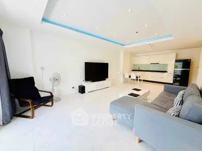 Spacious modern living room with open kitchen and sleek furnishings