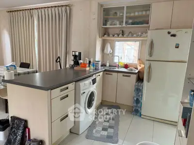Modern kitchen with washing machine and ample storage space