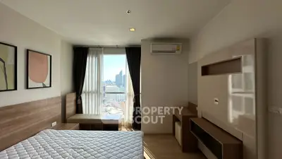 Modern bedroom with city view, featuring stylish decor and natural light.