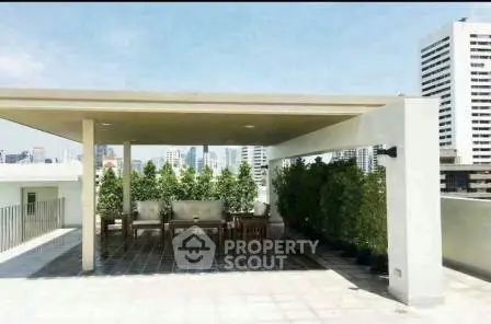 Stunning rooftop terrace with city views and lush greenery, perfect for relaxation and entertainment.