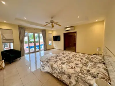 Spacious bedroom with pool view and modern decor