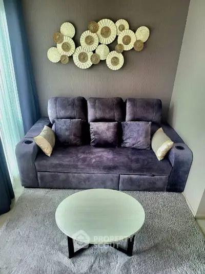 Modern living room with stylish grey sofa and artistic wall decor