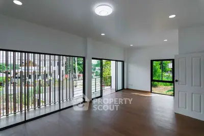 Spacious modern living room with large windows and garden view