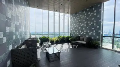 Luxurious high-rise balcony with stunning city view and modern seating area