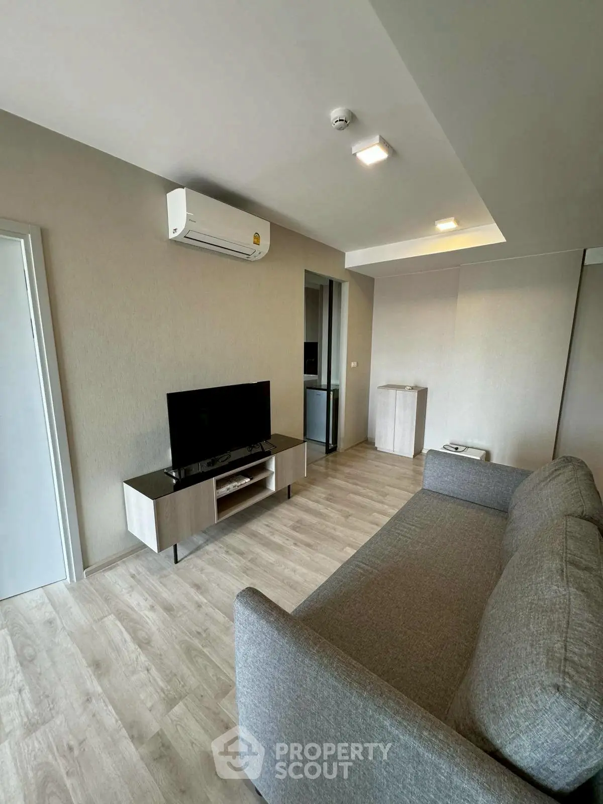 Modern living room with sleek furniture and air conditioning, perfect for comfortable living.