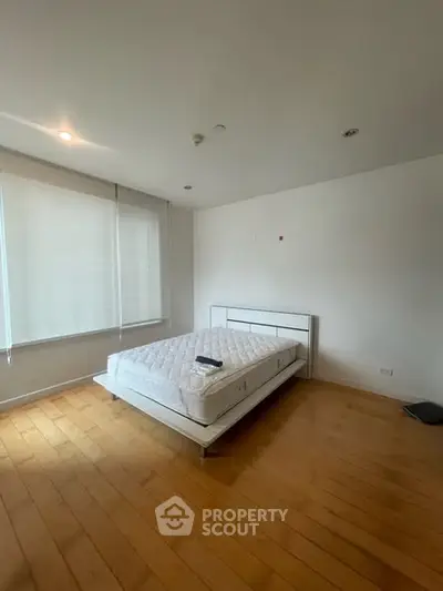 Spacious bedroom with modern bed and wooden flooring