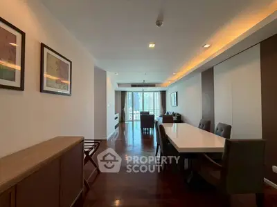 Spacious modern living room with elegant dining area and city view.