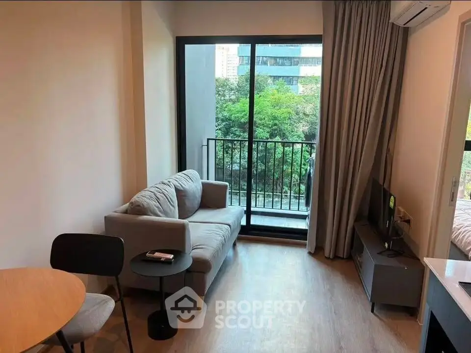Cozy living room with balcony view in modern apartment