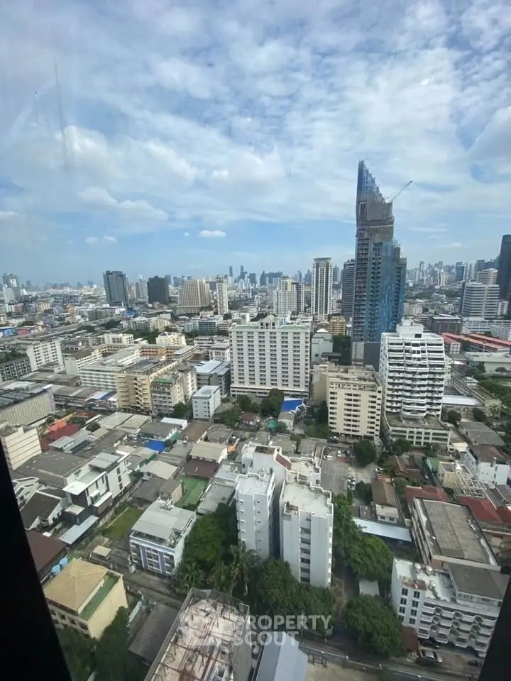 Stunning cityscape view from high-rise building window showcasing urban skyline.