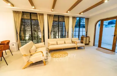 Spacious living room with modern furniture and large windows