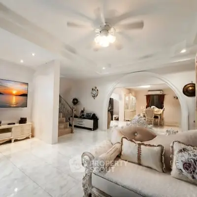 Luxurious living room with elegant decor and open layout, featuring plush seating and ambient lighting.