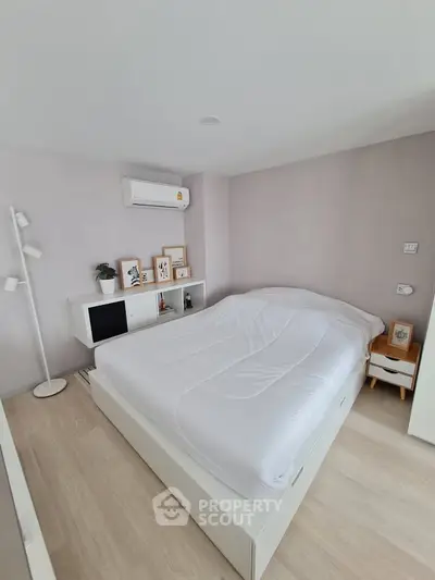Modern minimalist bedroom with white furniture and cozy decor