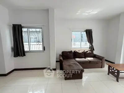 Spacious living room with modern sofa and natural light