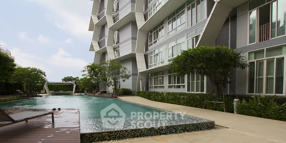 Modern condominium with luxurious poolside view and lush greenery