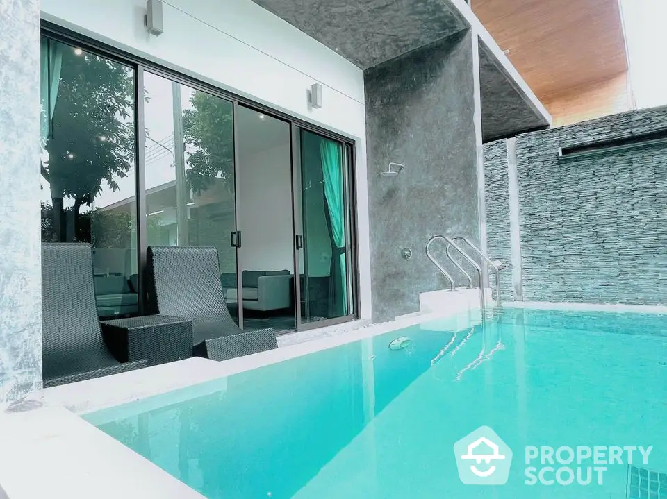 Luxurious modern villa with private pool and stylish outdoor seating area.