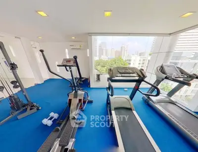 Modern gym with city view and state-of-the-art equipment
