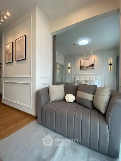 Stylish modern living room with cozy gray sofa and elegant wall art