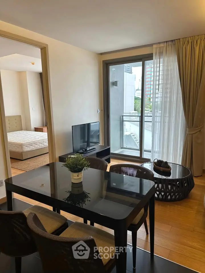 Modern living room with dining area and balcony view in a stylish apartment.