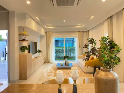 Spacious modern living room with elegant decor and large windows offering natural light.