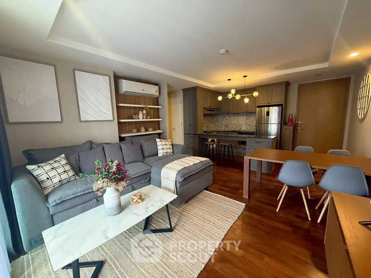 Modern living room with stylish furniture and open kitchen layout, perfect for urban living.