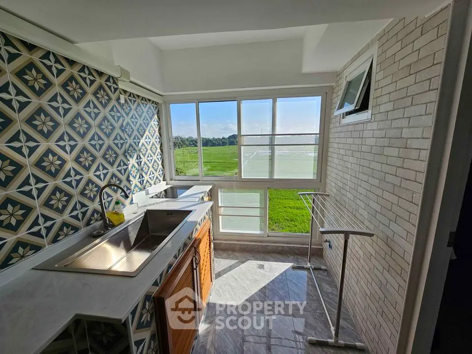 Charming kitchen with scenic view and stylish tile backsplash